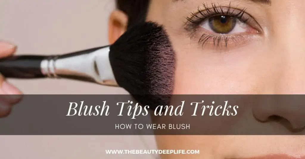 Woman applying blush makeup