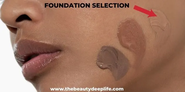 Woman with three colors of foundation on her jawline