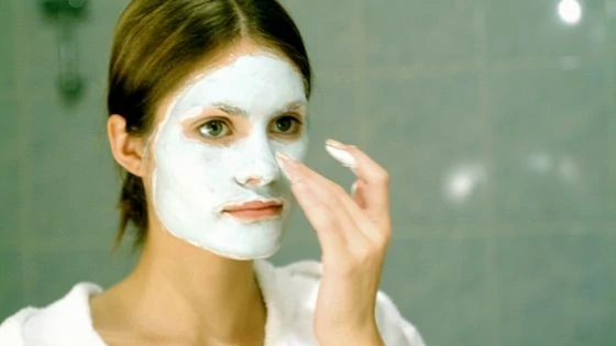 Woman trying a face mask for a self-care beauty routine
