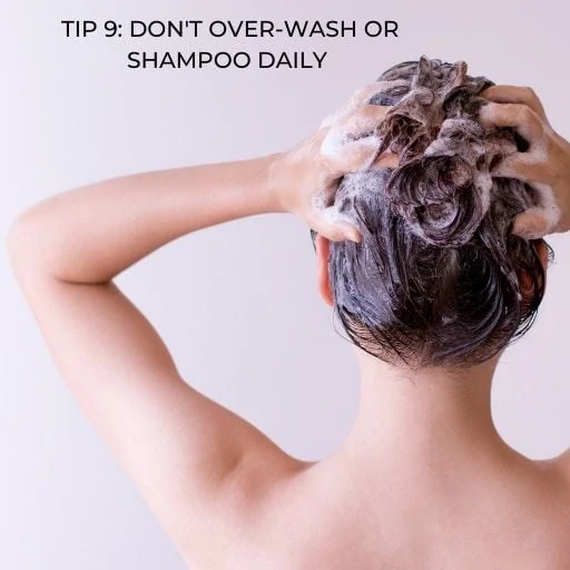 woman washing her hair with text overlay - tip don't over-wash or shampoo daily