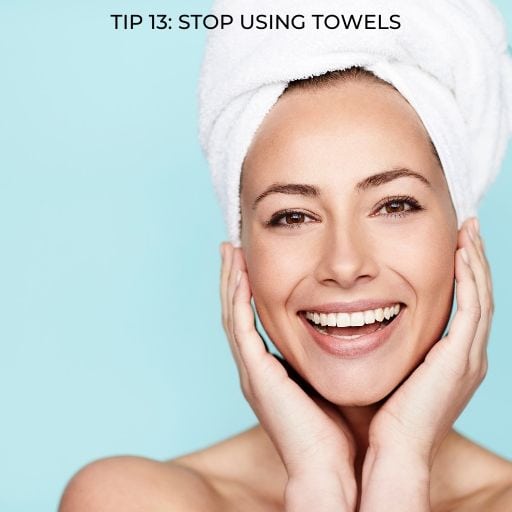 woman with towel wrapped around her hair on the head with text overlay - tip 12 stop using towels