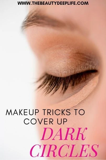 woman with concealer under her eye with text overlay - Makeup Tricks to Hide Dark Circles