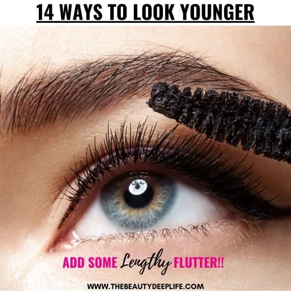 woman's eye as she applies mascara with text overlay 14 ways to look younger
