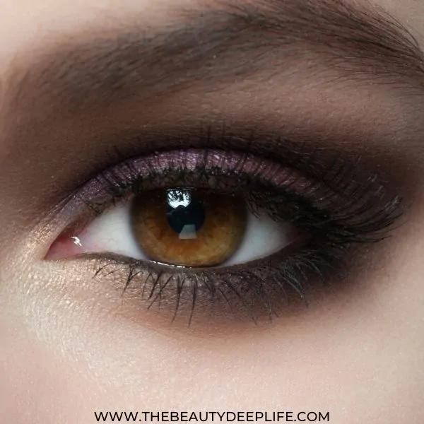 woman's brown eye with a purple smoky eyeshadow makeup look to make her eyes pop
