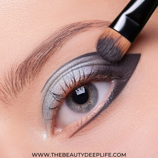 woman's blue eye with gray and silver eye makeup