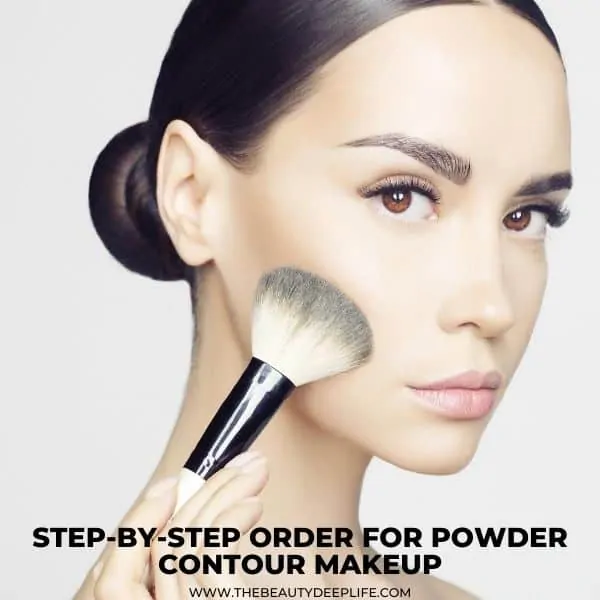 woman using a makeup brush to contour her cheeks