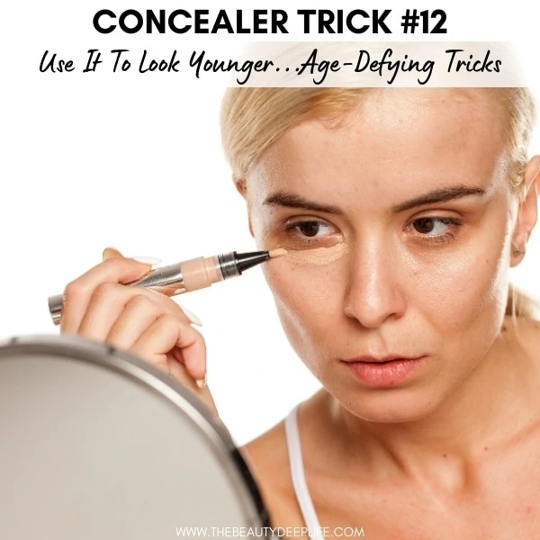 woman applying concealer to look younger