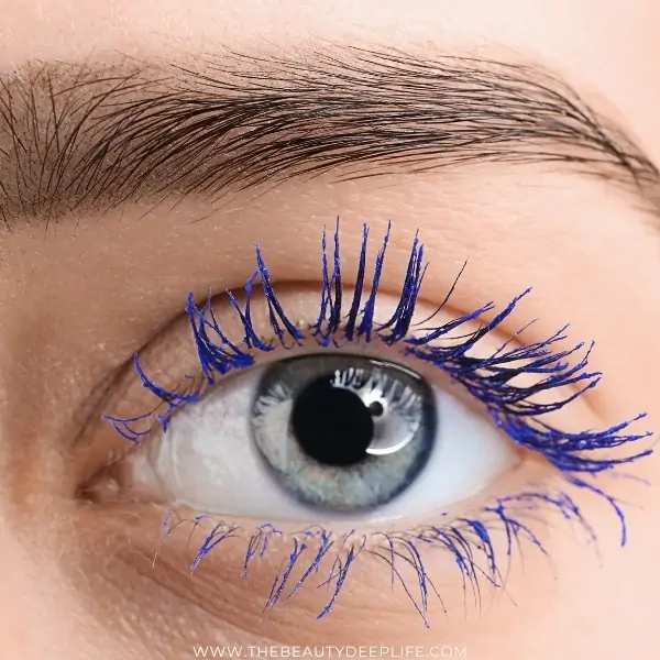 woman's blue eye with colored mascara