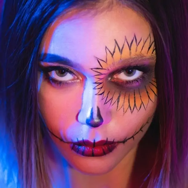 woman with sunflower scarecrow halloween makeup
