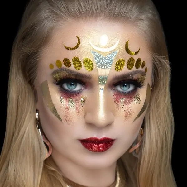 woman with creative halloween makeup that has stickers and glitter