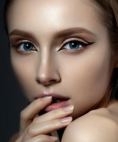 woman with blue eyes and a dramatic eye makeup look with liner and eyeshadow