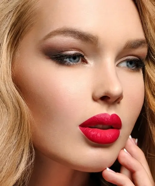 woman with blue eyes, red lipstick, and smokey eyeshadow look