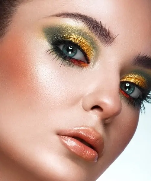 woman with green and gold eyeshadow makeup look