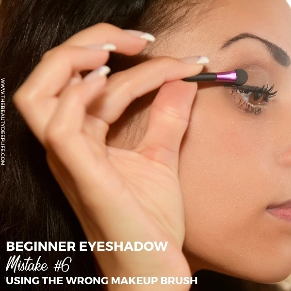 woman applying eyeshadow with a sponge applicator and text overlay beginner eyeshadow mistake using the wrong makeup brush