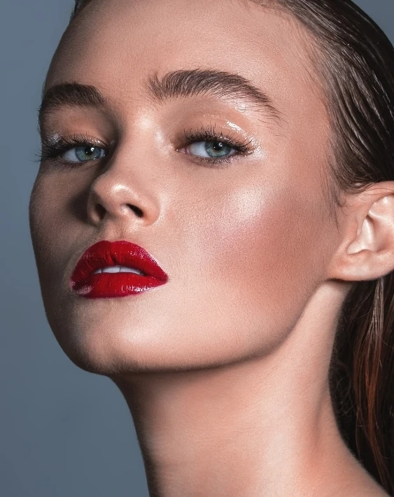 woman with glossy eyelids and red lipstick