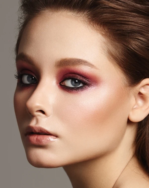 woman with colorful smokey eye makeup and glossy lips for summer