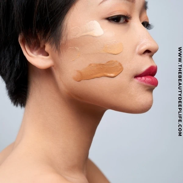 woman with foundation makeup swatches on her face