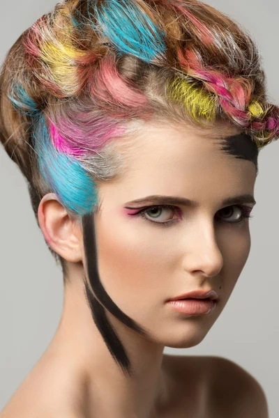 young woman with colorful hair and creative makeup