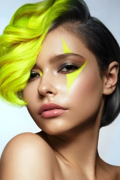 woman with an easy halloween makeup look that features bright neon colors