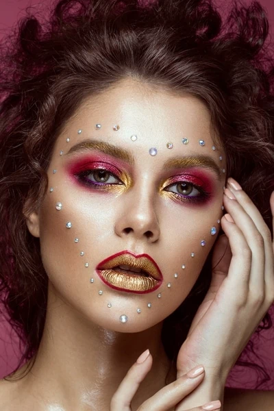 woman with creative halloween makeup look with rhinestones
