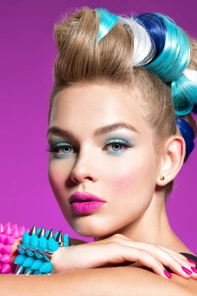 woman with colorful makeup and hair