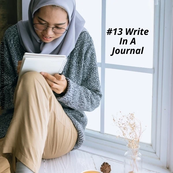 young woman writing in a journal to pamper her mind