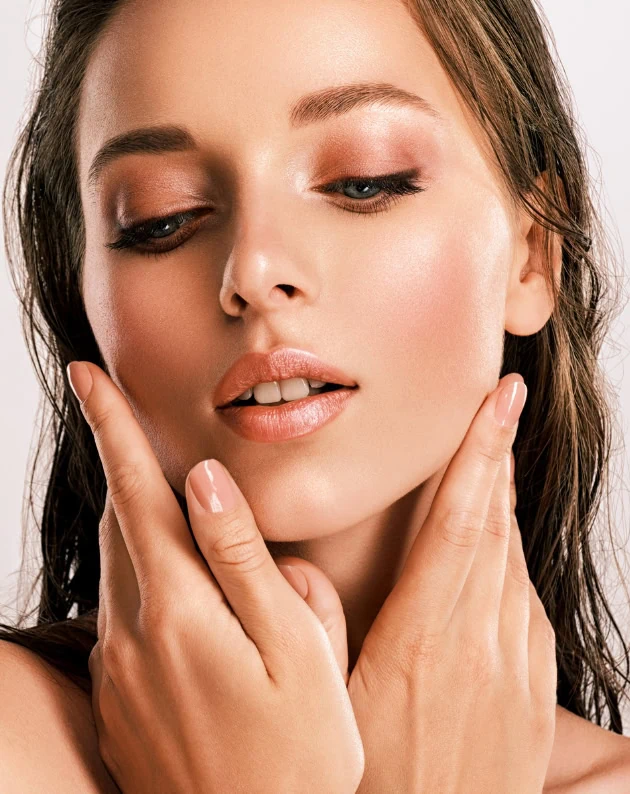 woman with soft shimmery pink makeup look for summer