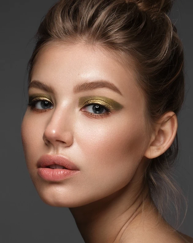 young woman with antique gold eye makeup look for summer