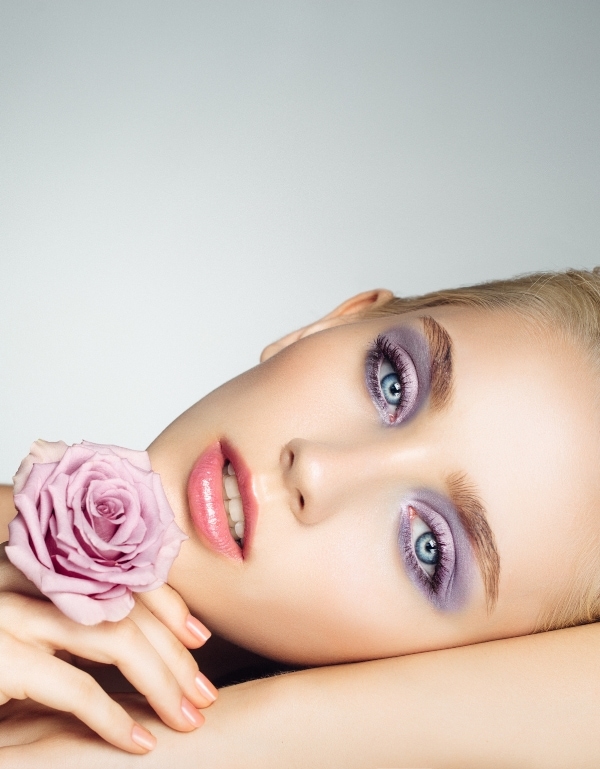 beautiful blue eyed woman with a light purple eyeshadow look