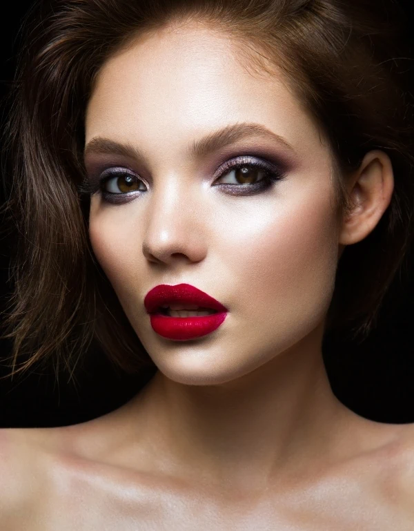 woman with purple eyeshadow a red lipstick