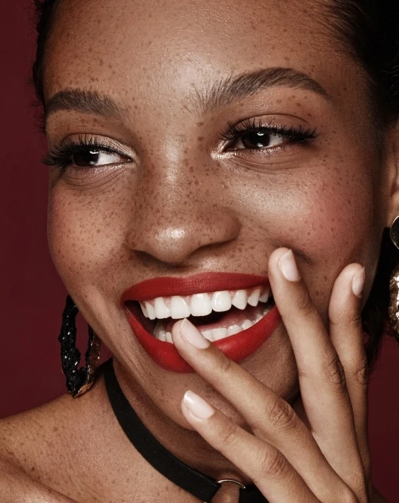 black woman with shimmery eyeshadow and red lipstick