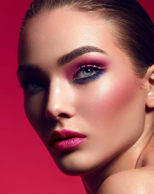 woman with blue eyes and pink and blue eyeshadow makeup