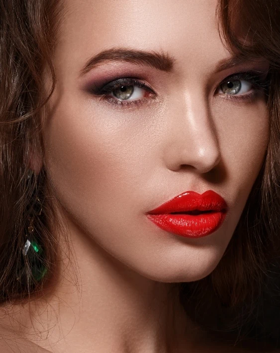 woman with bold eye makeup and red lips