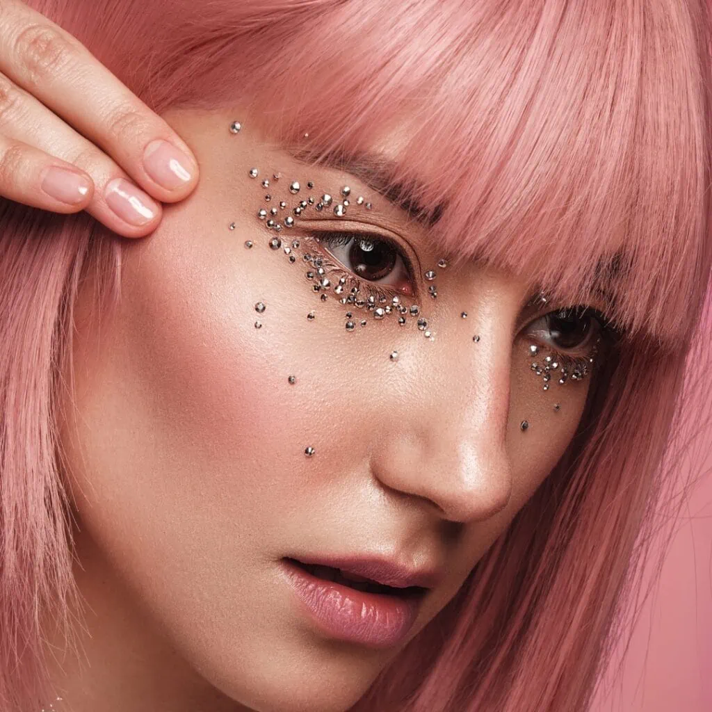 woman with a pink wig and rhinestone makeup