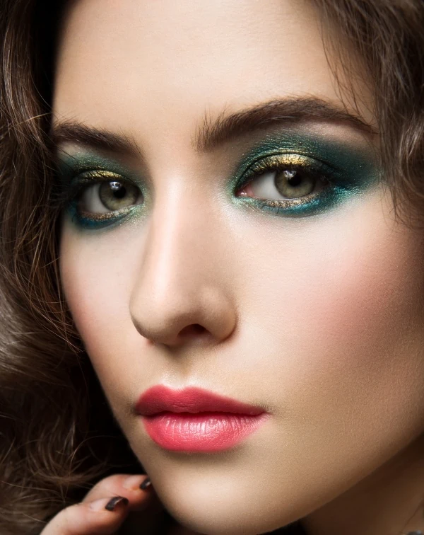 woman with green eyes and a green and gold eyeshadow 