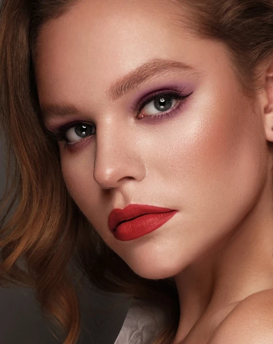 woman with matte purple eyes makeup with red lips