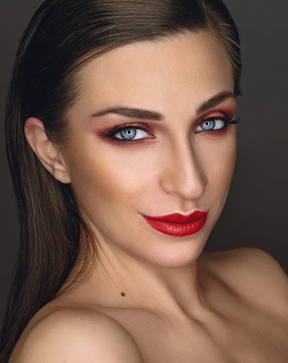 woman with copper and red eyeshadow with red lipstick makeup look