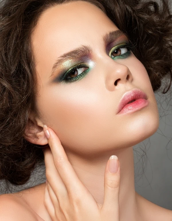 woman with brown eyes and a green eye makeup
