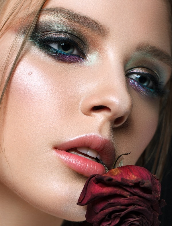woman with blue eyes and a green eyeshadow look