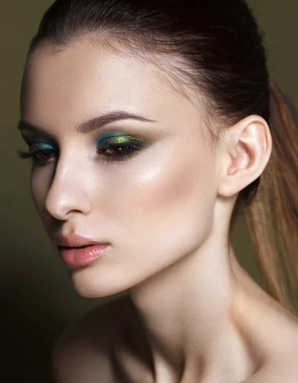 woman with a blue and green eye makeup