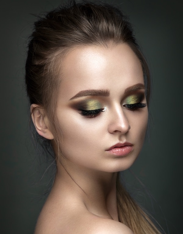 woman with a green and brown eyeshadow look
