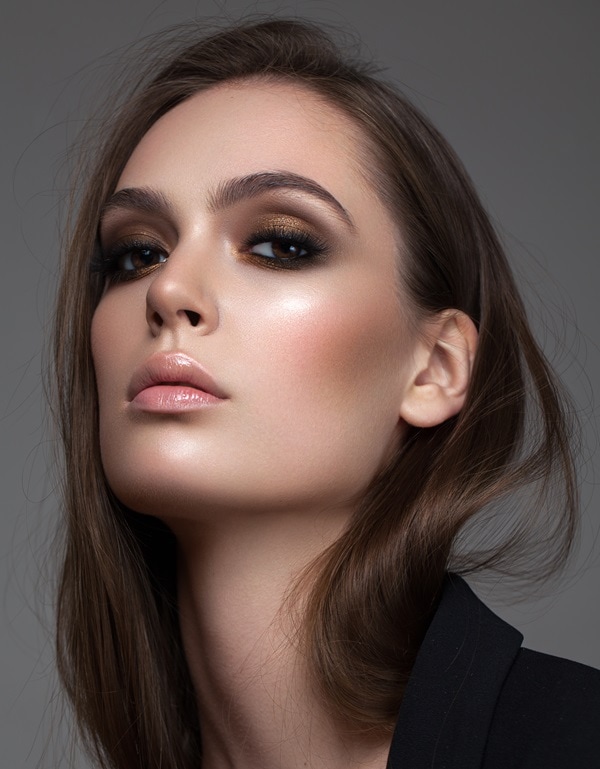 woman with dark brown eyes and a gold and dark brown eyeshadow look