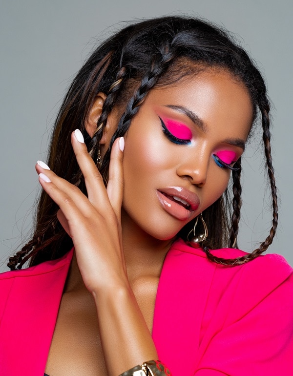 woman with dark skin tone and a pink eyeshadow look