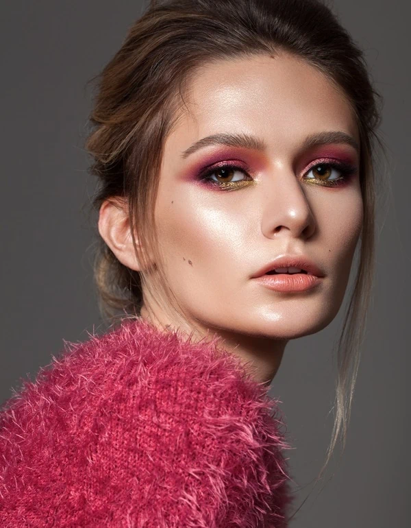 woman with brown eyes and a dark pink eyeshadow look
