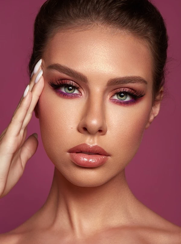 woman with green eyes and a pink makeup look