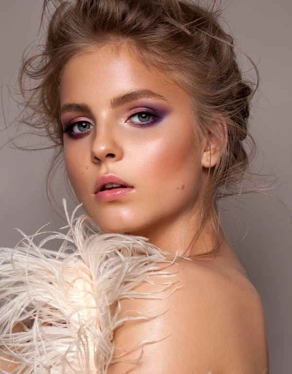 woman with blue eyes and a pink and purple eyeshadow look