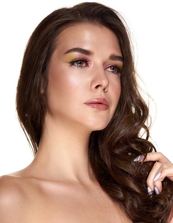 woman with green eyes and a pink eyeshadow look mixed with yellow-green