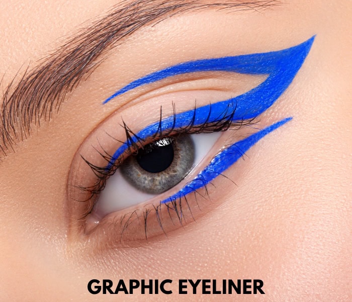 woman's eye with a bright blue graphic eye makeup