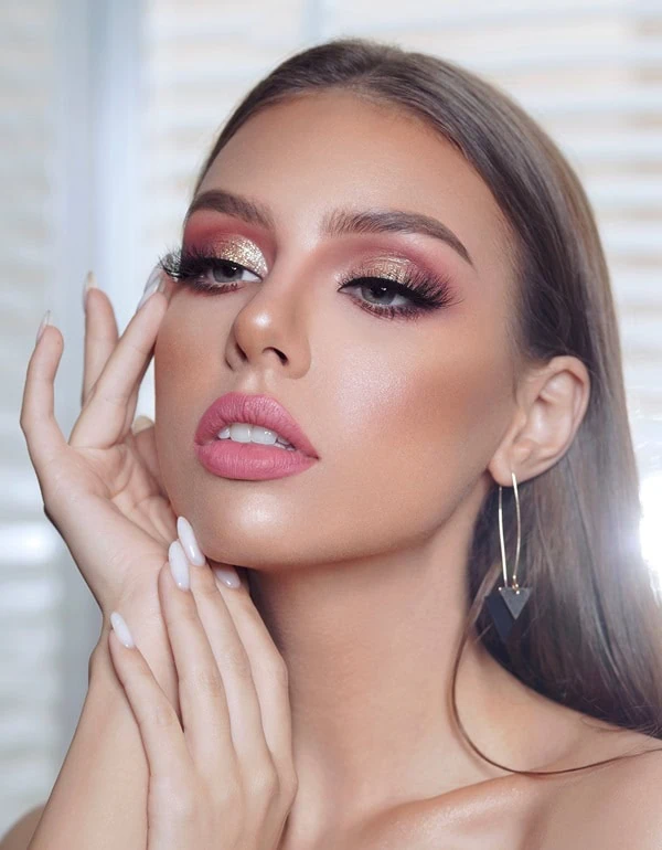 woman checking her makeup in a mirror as she gets ready for date night