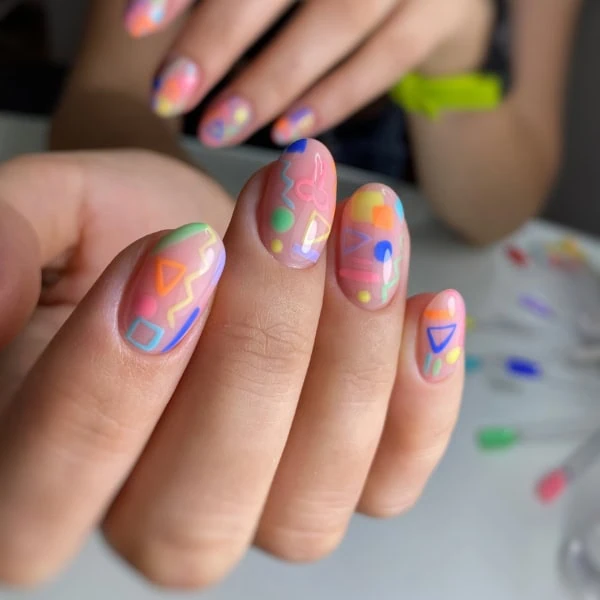 female hands with geometric colorful nails